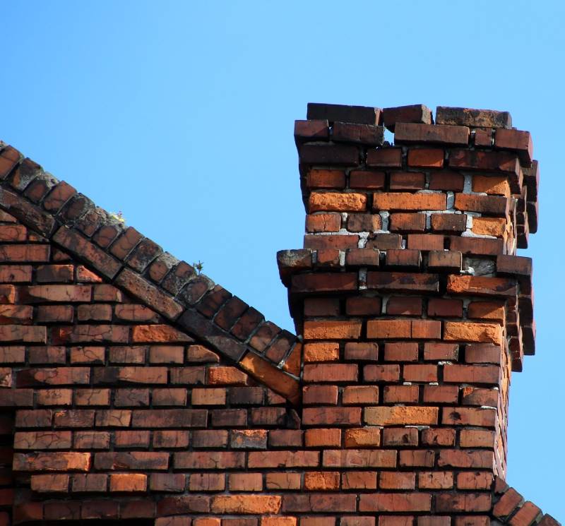Damaged chimney on an Roselle home showing cracks and missing mortar